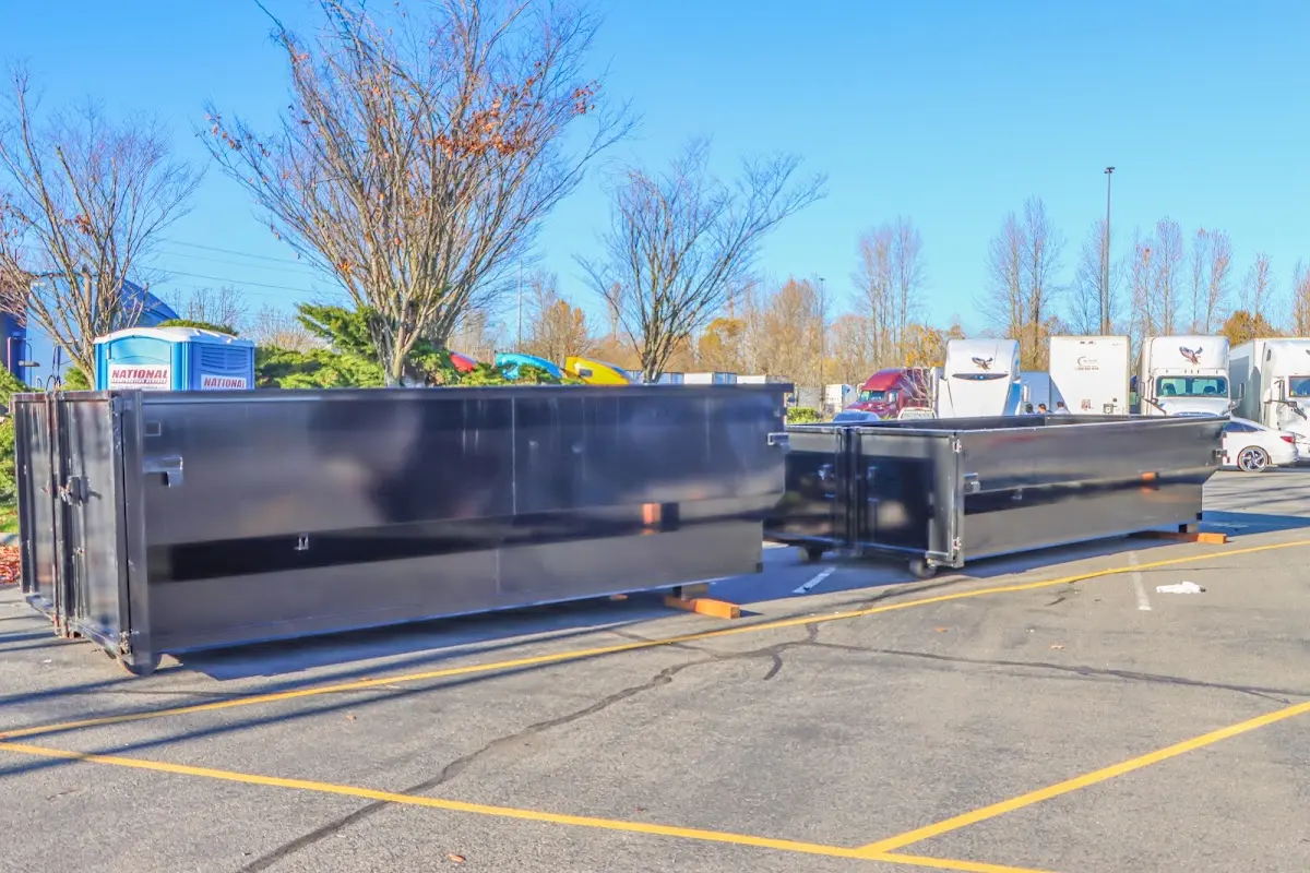 Professional dumpster rental service with roll-off container on residential driveway in Pelham Manor